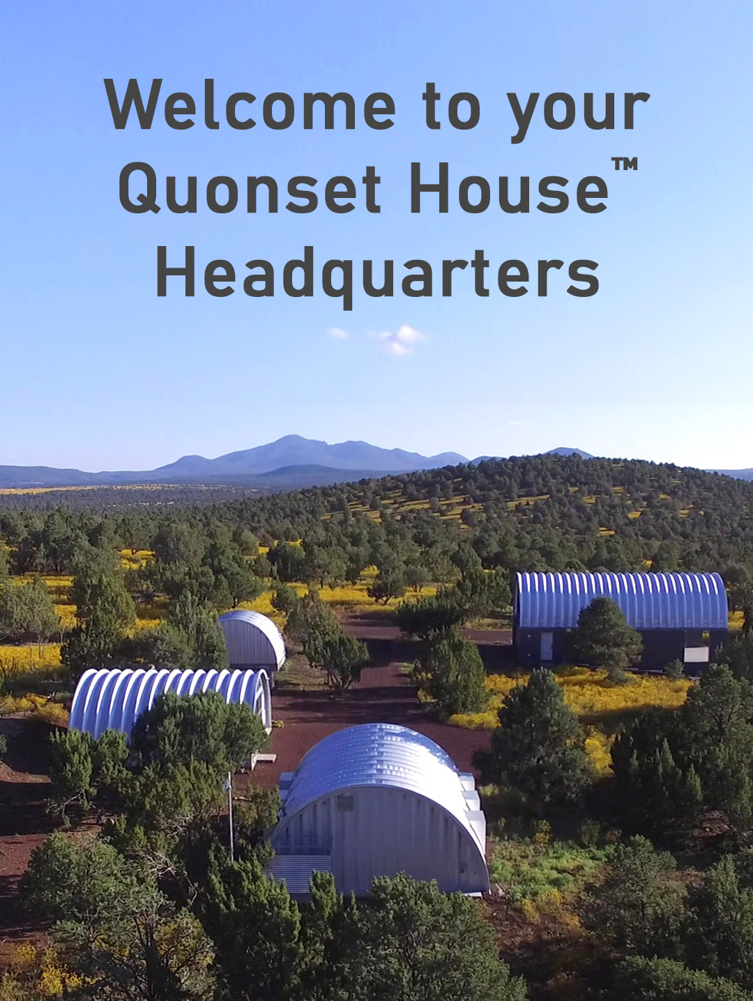 Image of a landscape mountains in the distance and Quonset huts in the foreground, and the words, "Welcome to your Quonset House headquarters."